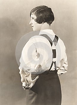 Side view of woman wearing suspenders and men's trousers, 1920s