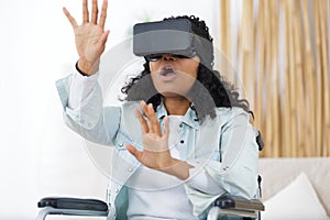 side view woman on wheelchair using virtual reality mask
