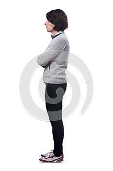 Side view of a woman in white background, arms crossed
