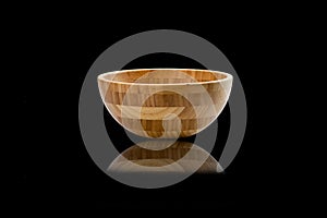 Side view of a wooden cup on a black isolated background. Cups.
