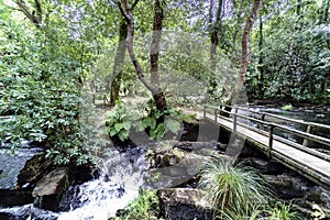 Side view of a wooden pedestrian bridge over the river called an