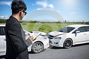 Side view of writing on clipboard while insurance agent