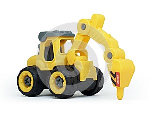 side view of yellow plastic tractor drill toy isolated on white background.