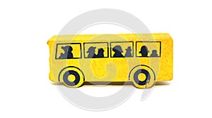 Side view of a yellow wooden toy school bus on a white background