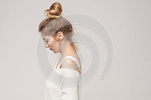 Side view young adult unwell blonde woman looking down.