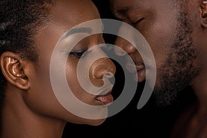 side view of young african american couple with water drops on faces posing