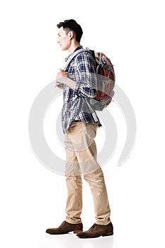 Side view of young Asian backpacker