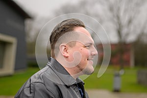 Side view of a young attractive man in his twenties looking friendly