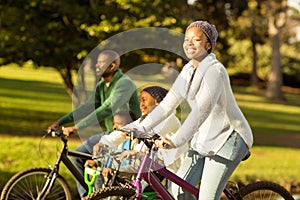 Side view of a young family doing a bike ride