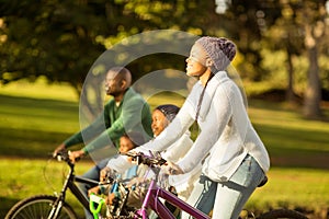 Side view of a young family doing a bike ride