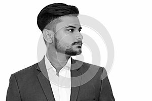 Side view of young handsome Indian businessman