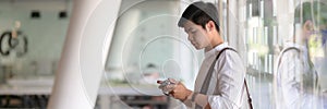 Side view of young male photographer checking his picture on digital camera