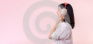 Side view young smiling cheerful fun woman she wear pink shirt white t-shirt headphones listen to music use mobile cell phone