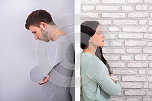 Unhappy Couple Standing Back To Back