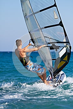 Side view of young windsurfer