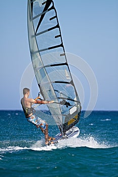 Side view of young windsurfer