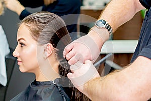 Woman is receiving haircut by hairdresser