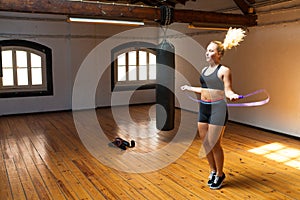 Side view of young woman using jump rope