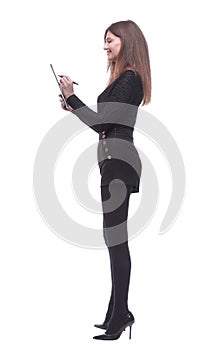 Side view. young woman writing something to the clipboard.