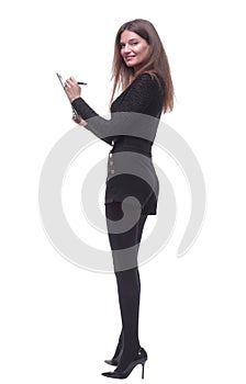 side view. young woman writing something to the clipboard.