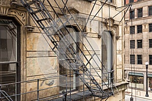 Side of vintage art deco building with steel fire escape in urban Chicago