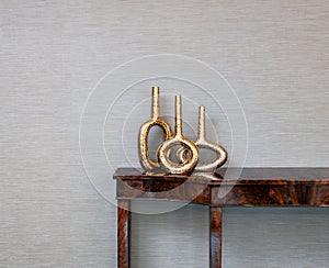 Sideboard in front of a grey wall and art objects