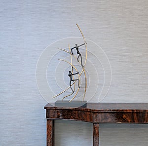 Sideboard in front of a grey wall and art objects