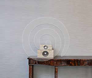 Sideboard in front of a grey wall and art objects