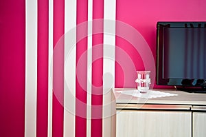 Sideboard with TV and red striped wall