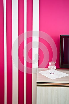 Sideboard with TV and red striped wall