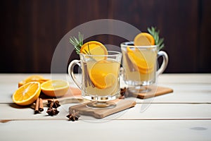 sidebyside hot toddies, one orange slice, one lemon