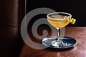 Sidecar Cocktail with Lemon Twist and Sugar in Bar