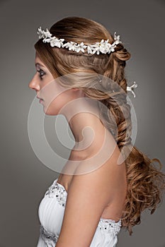 Sideview of beautiful woman with small flowers photo