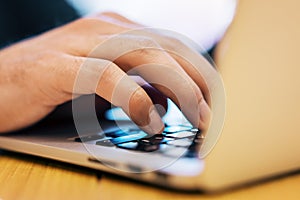 Sideview of businessman using laptop on desk