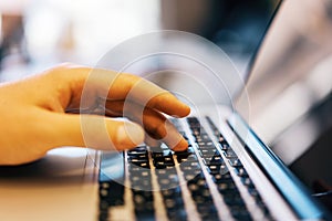 Sideview of businessman using laptop on desk top