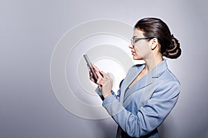 Sideview Portrait of Attractive Young Businesswoman Using Smartphone
