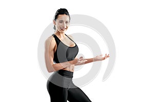 Sideview of smiling athletic model posing on white studio background.