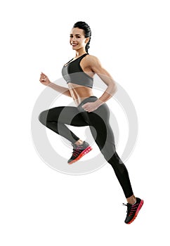 Sideview of smiling woman jumping on white background.