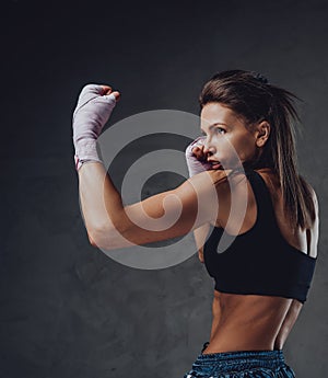 Sideview of a woman with bandages arms in defensive stance