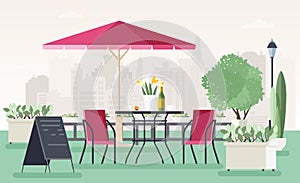 Sidewalk cafe or restaurant with table, chairs, umbrella, potted plants and welcome board standing on street against photo