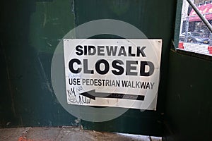 Sidewalk Closed Sign Posted on Wall in New York City