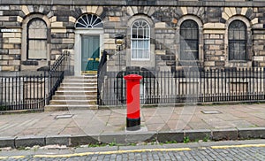 Sidewalk, facades and typical red british postbox