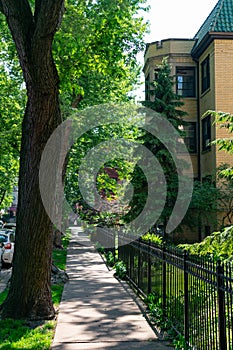 Sidewalk with a Fence and Residential Buildings in the Edgewater Neighborhood of Chicago