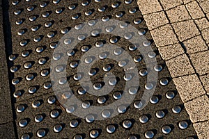 Sidewalk guides for blind. Concrete cobblestones on walkway for blindness people