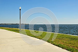 Sidewalk and lamppost near the water