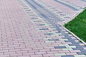 The sidewalk is lined with stone blocks of rectangular shape.