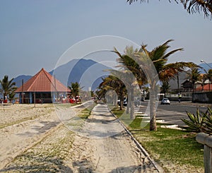 Sidewalk at Peruibe beach with palms trees