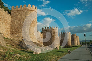 Sidewalk and stone towers on the large wall of Avila