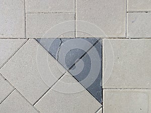Sidewalk with two black triangles, one broken