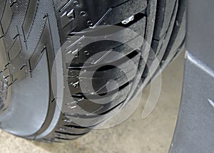 Polished sidewall of car tire on the alloy wheel rim close up photo